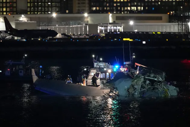 Emergency response units assess airplane wreckage in the Potomac River near Ronald Reagan Washington Airport on Jan. 30 in Arlington, Virginia. An American Airlines flight from Wichita, Kansas collided with a helicopter while approaching Ronald Reagan National Airport.